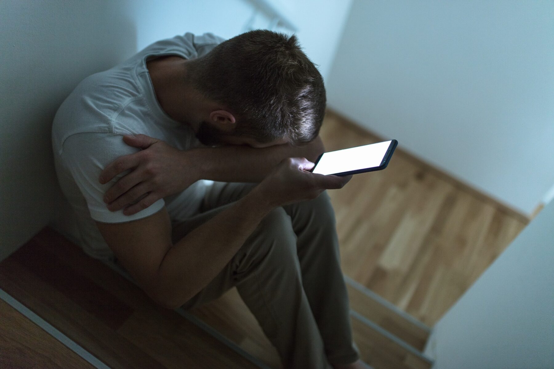 Depressed man sitting in the dark