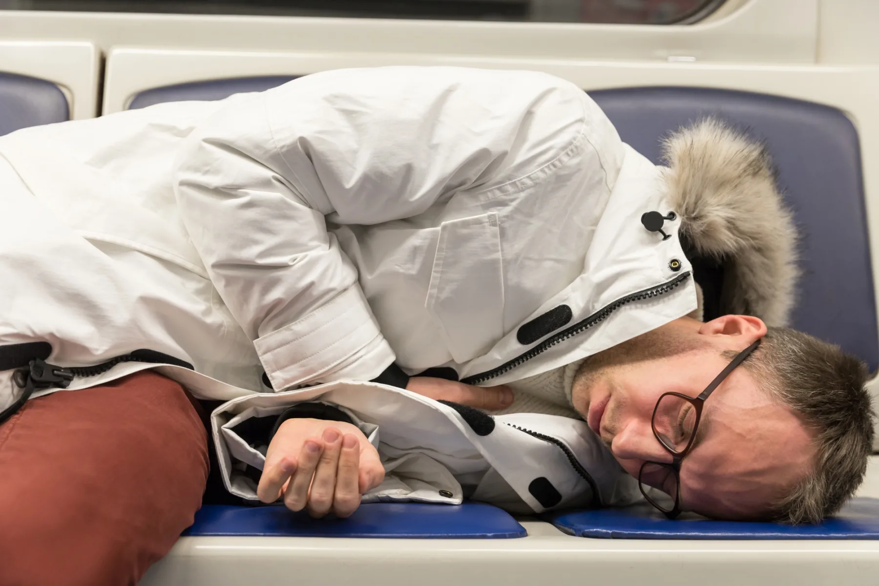 heart attack, young man lying on the seat in subway train